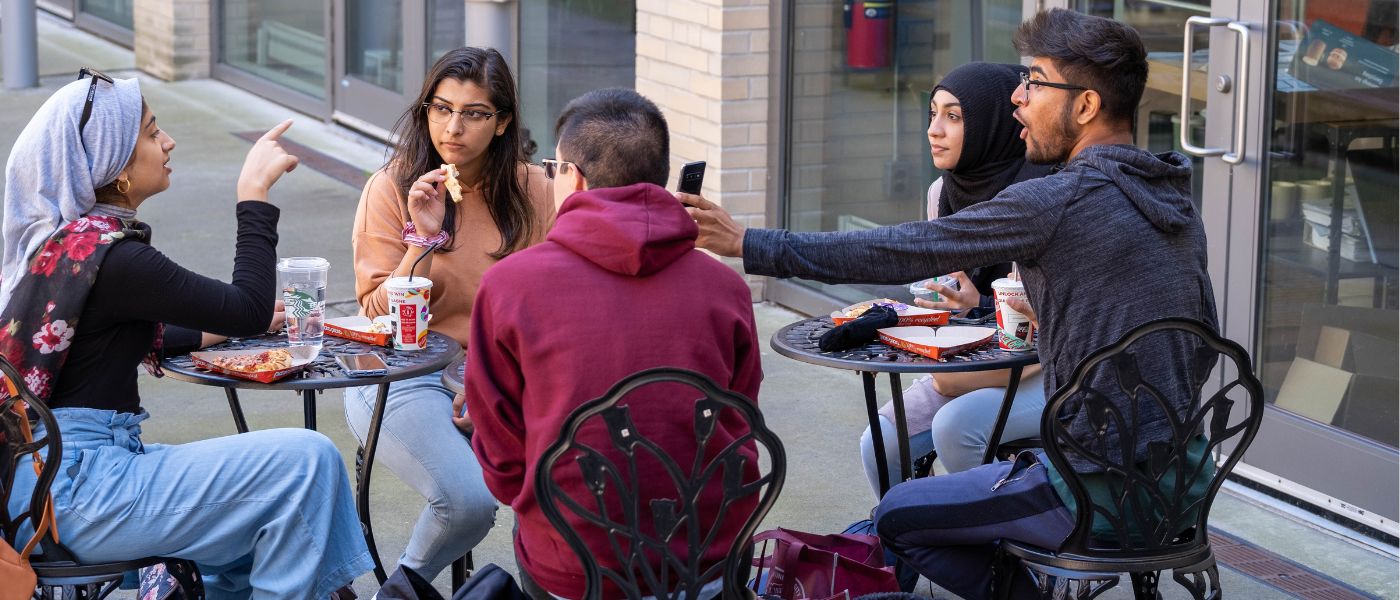 Students sitting outside on patio located outside Starbucks in MUSC during Welcome Week 2019