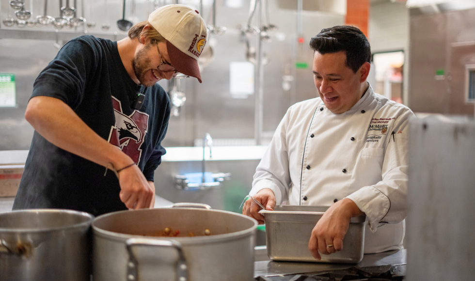 Achille, an MBA graduate student on exchange from France, cooks lasagna Bolognese with John Barreda, chef manager, Hospitality Services. (Photo credit: Gayathri Nunna)